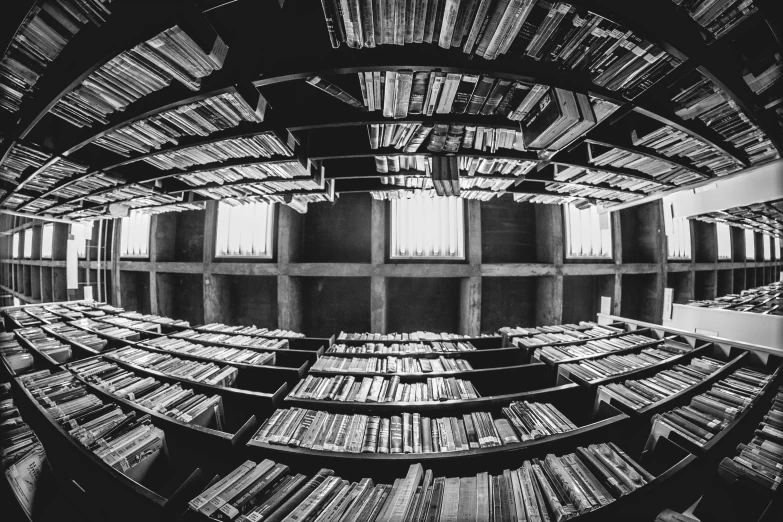 the reflection of a circular bookshelf in an art museum