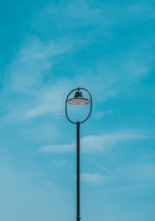 a black street lamp with a clear sky background