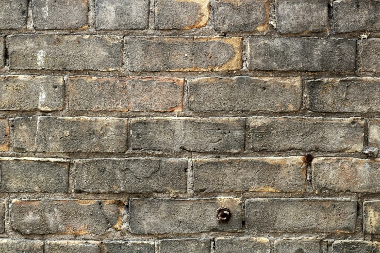 close up of grey wall with holes in concrete