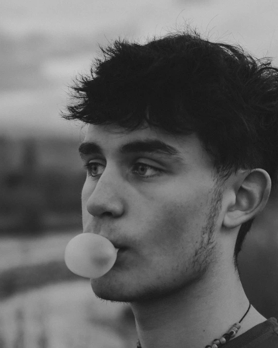 man with a nose full of bubbles in a black and white po