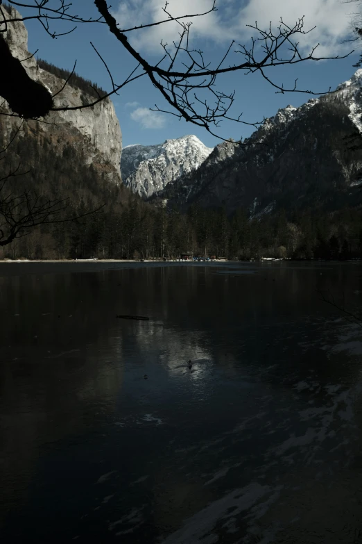 a black and white picture of mountains and water