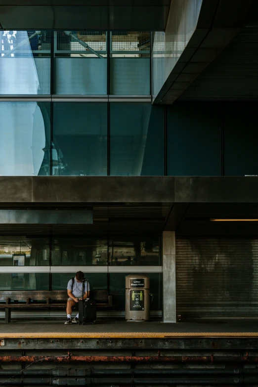 a man sitting on top of some steps near a building