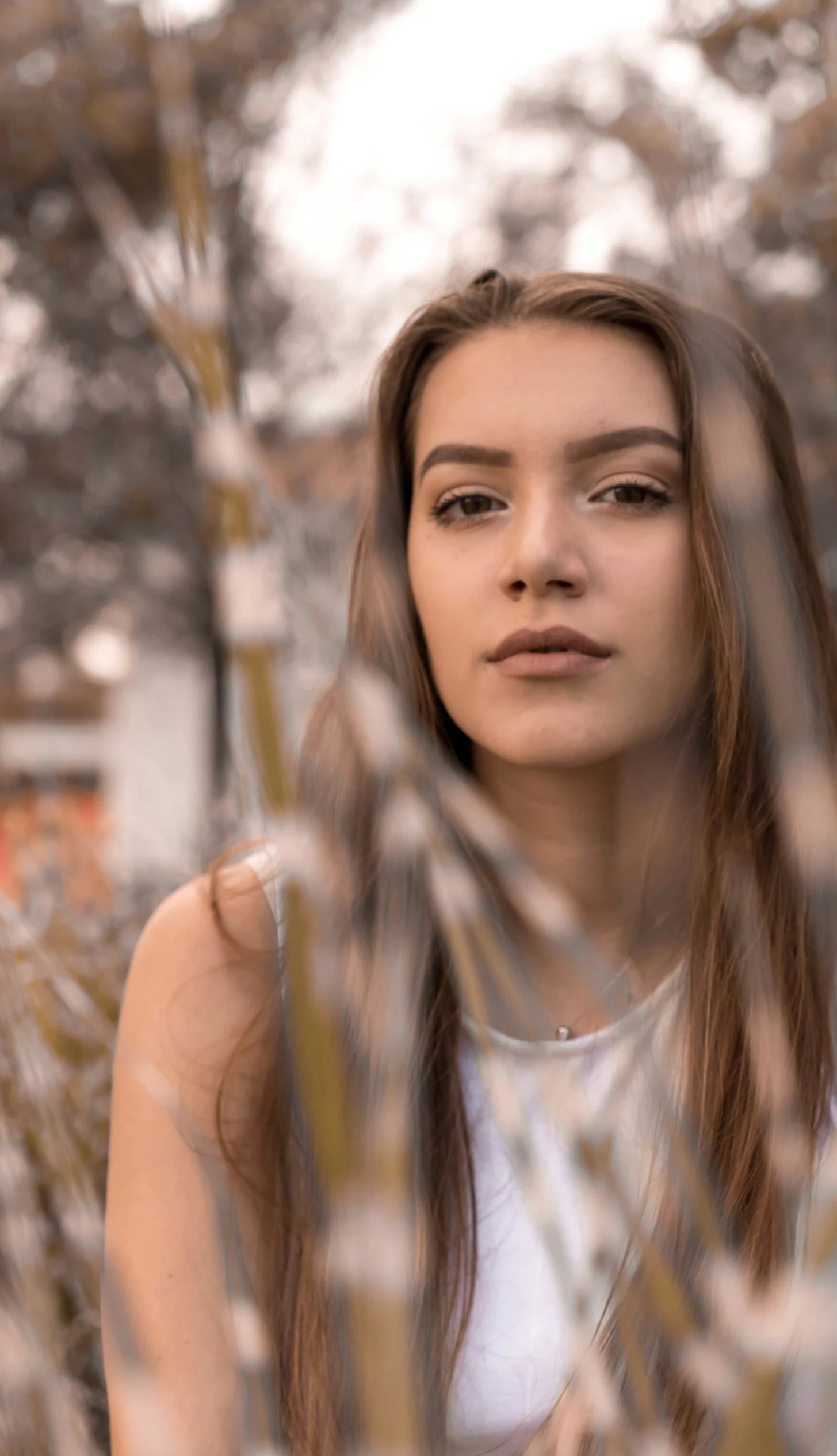 a young woman looks through a glass window