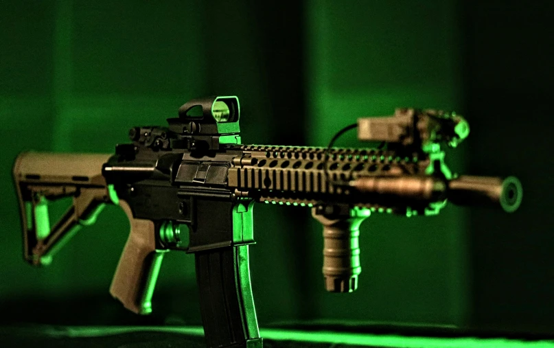 the gun is on a tripod in front of a green wall