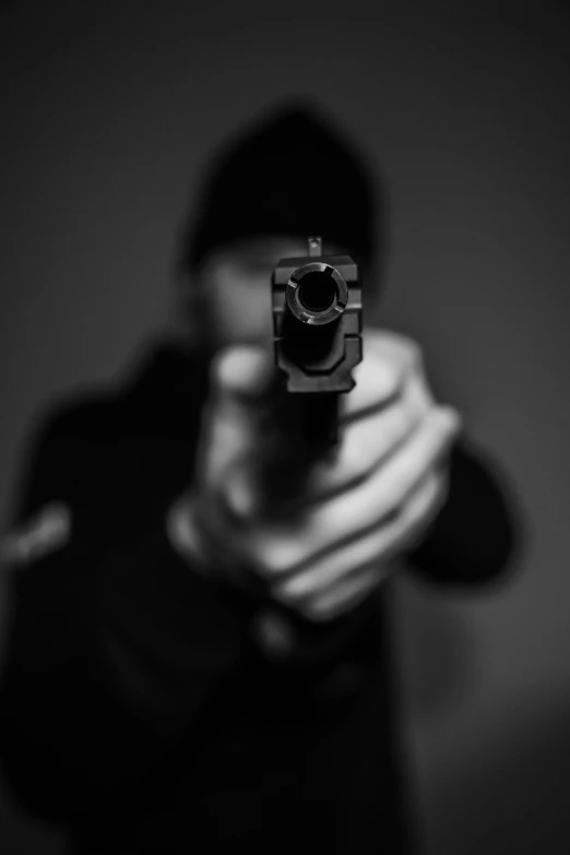 a black and white po of someone holding a gun
