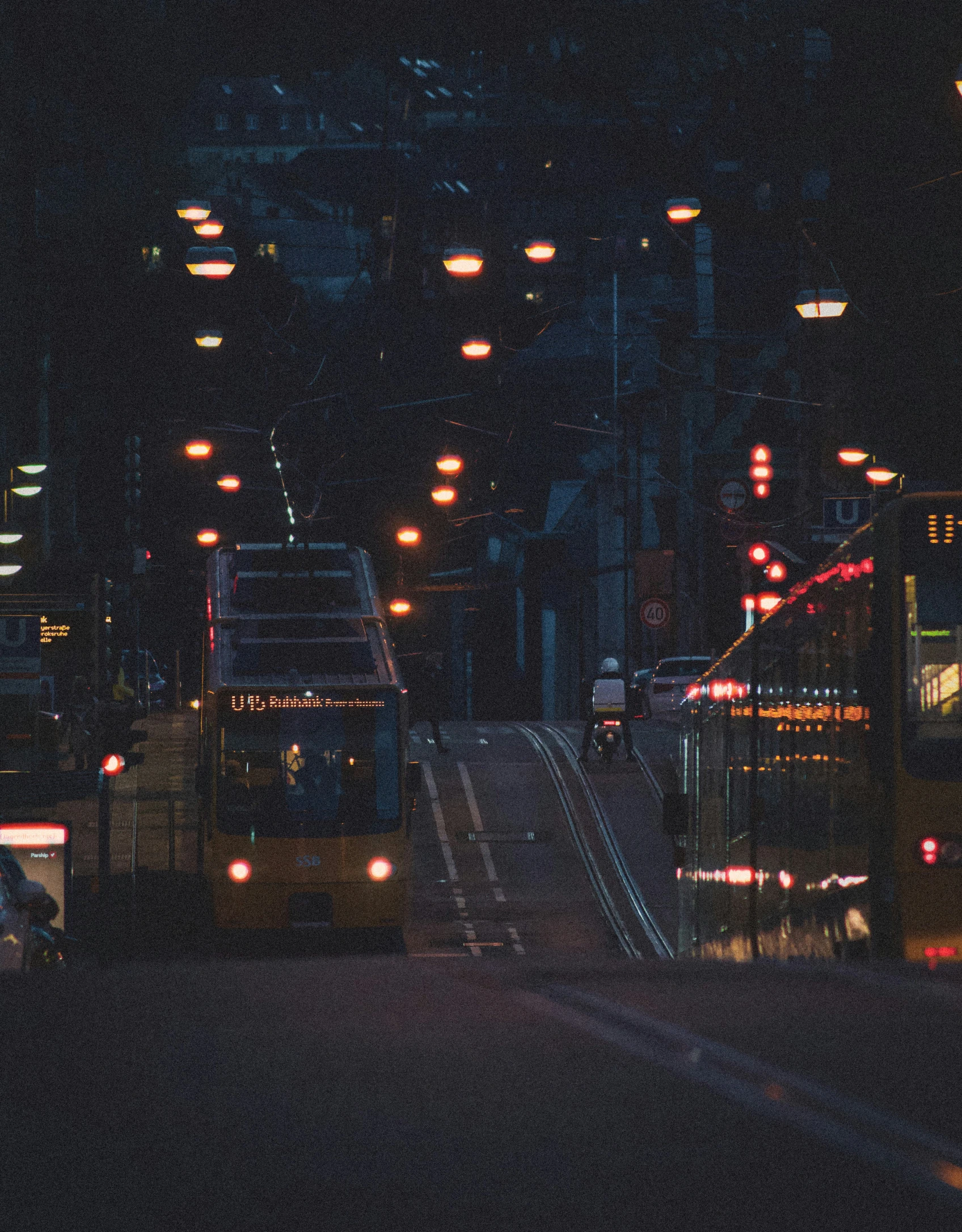 a dark street with lights on at night time