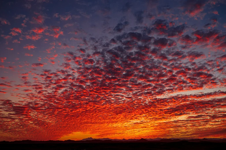 this is an image of a sunset with clouds in the sky