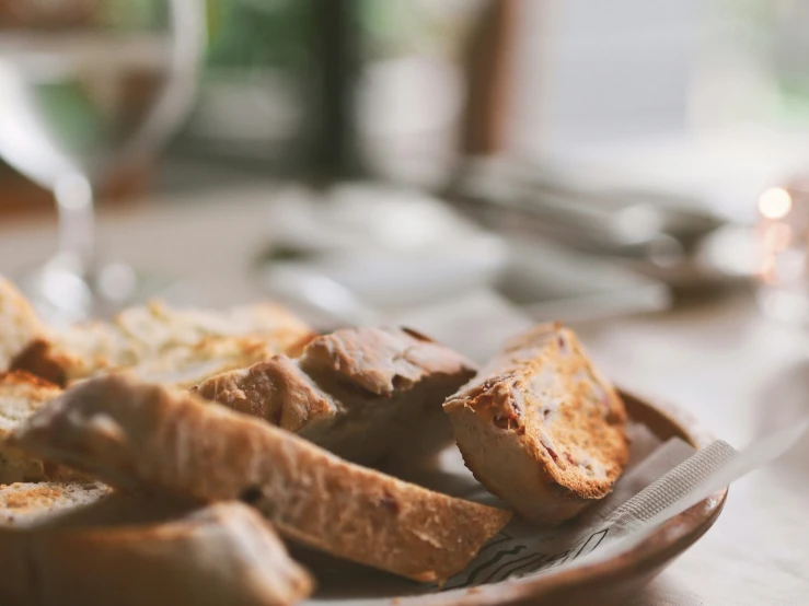 bread on a plate next to a glass