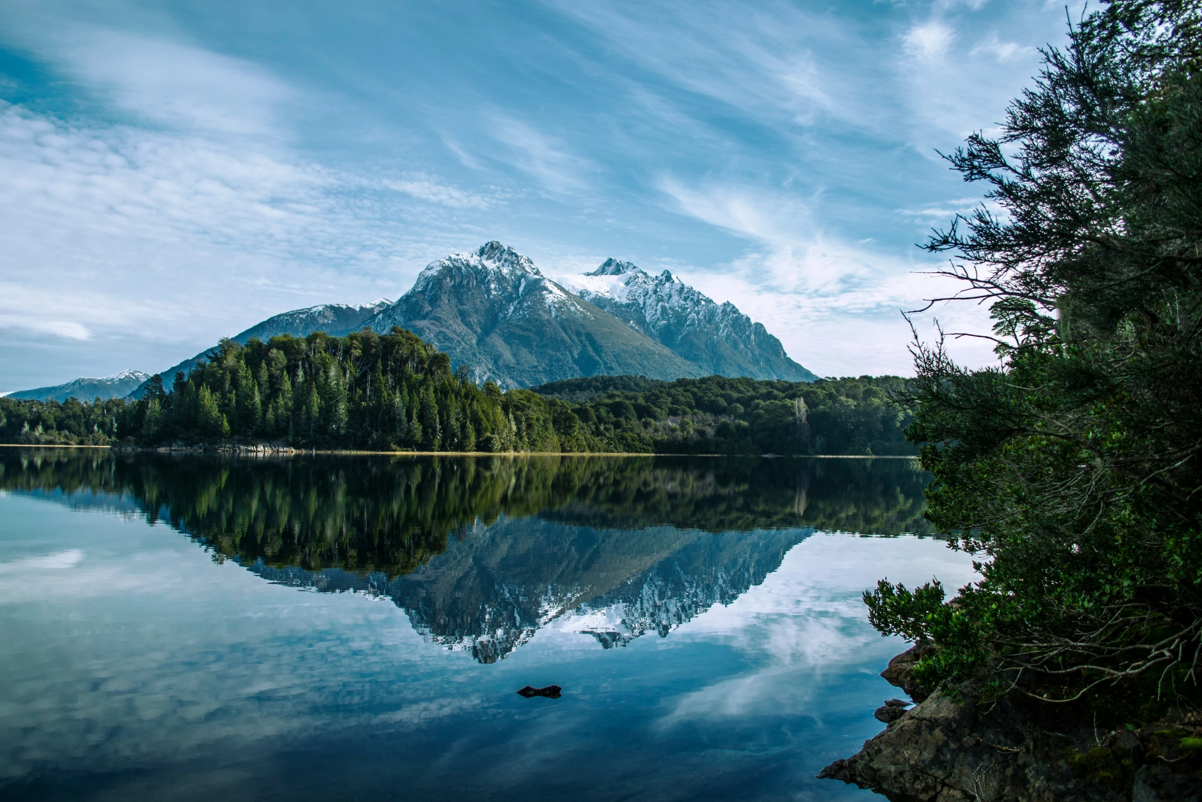 a body of water with a mountain in the background