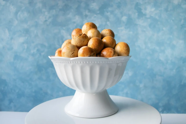 a small white bowl filled with cookies sitting on top of a counter