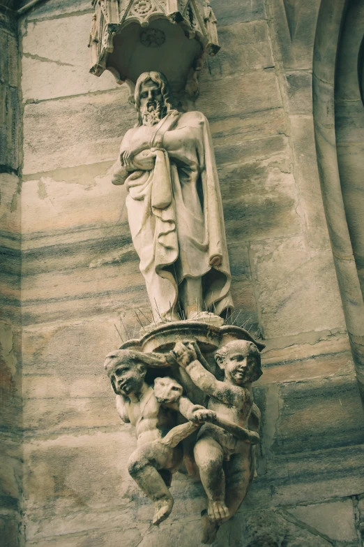 a statue next to a stone building