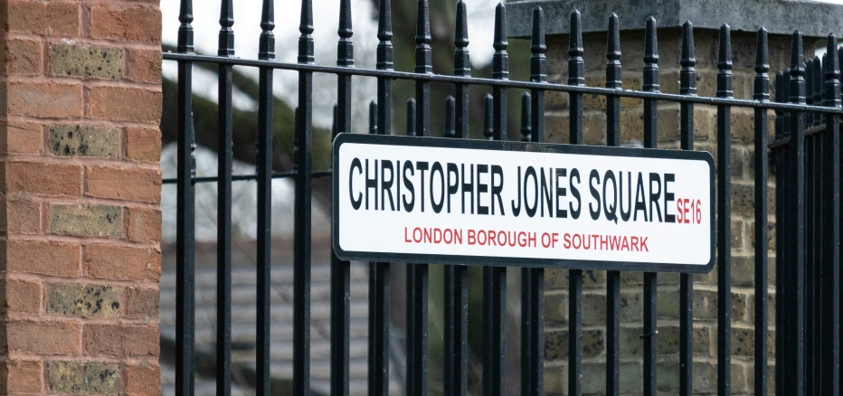 a black gate with a sign saying chop chopping bushes south street