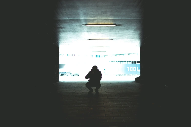 the person stands alone in an empty tunnel