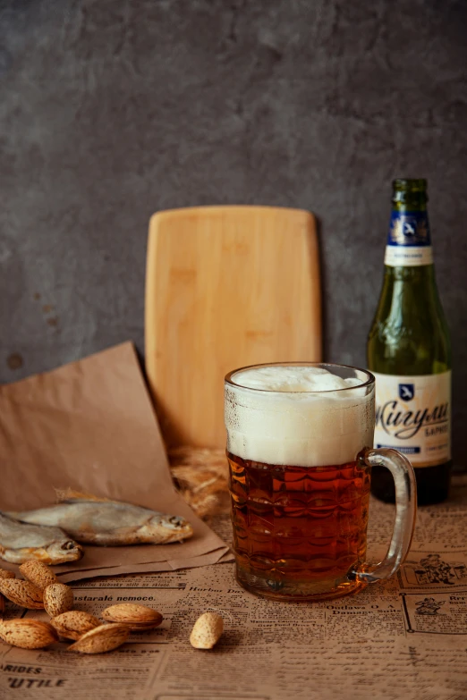 a large beer in a mug and small ers on the table