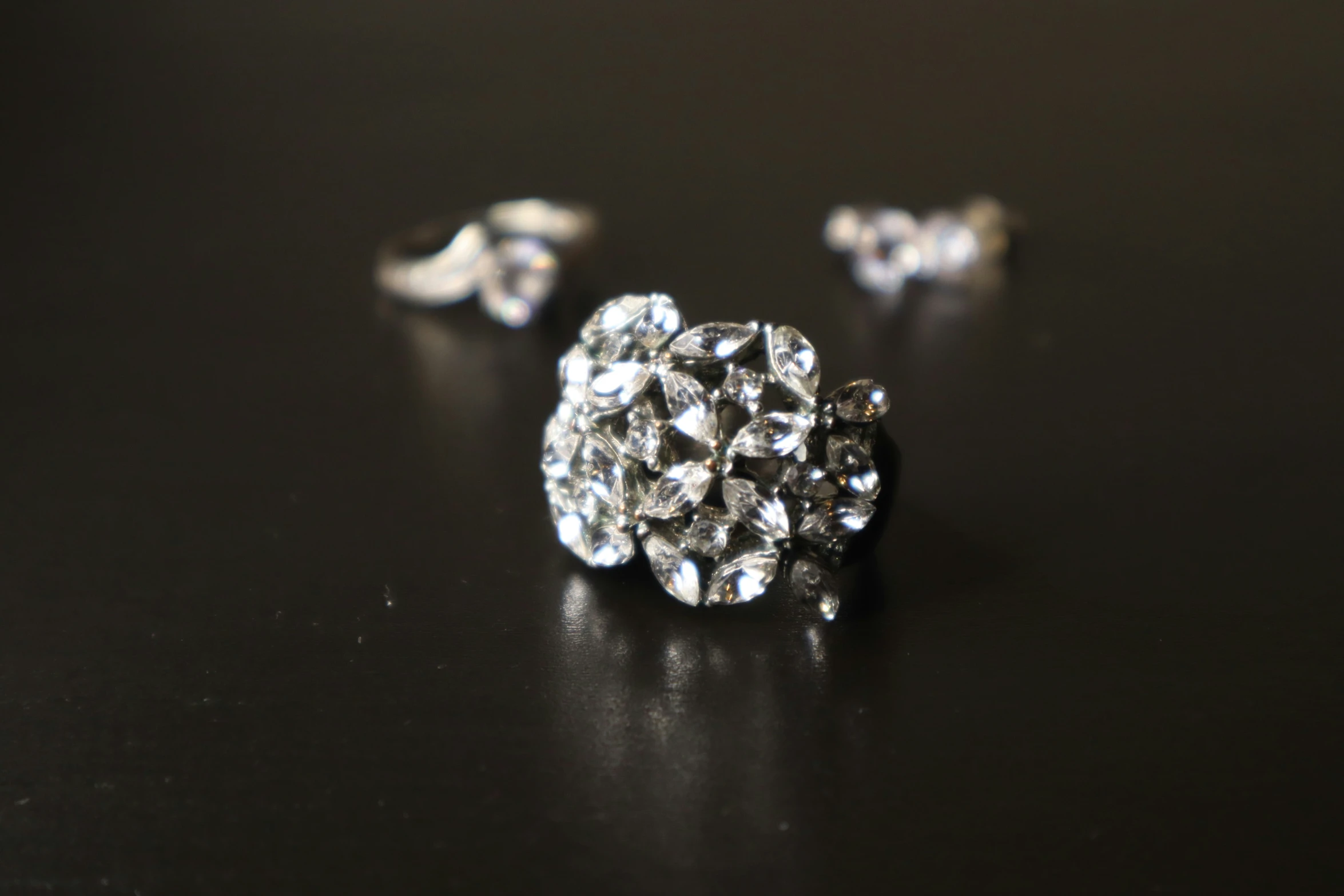 a close up of a diamond earring that is set on a table