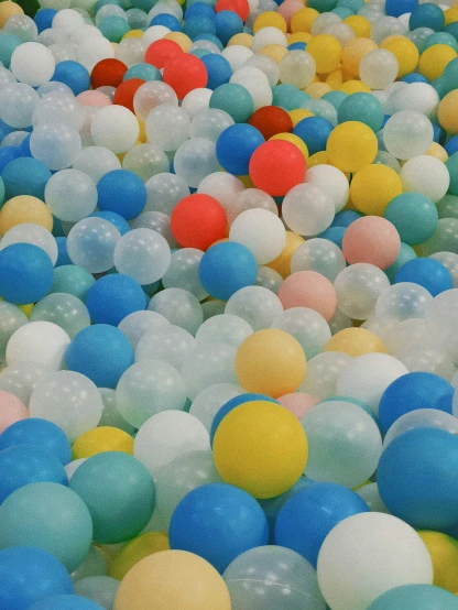 rows of ballons with multi - colored tails, all on white