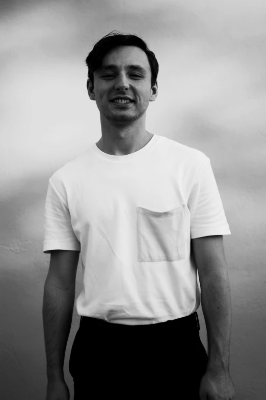 black and white pograph of man in a white t - shirt