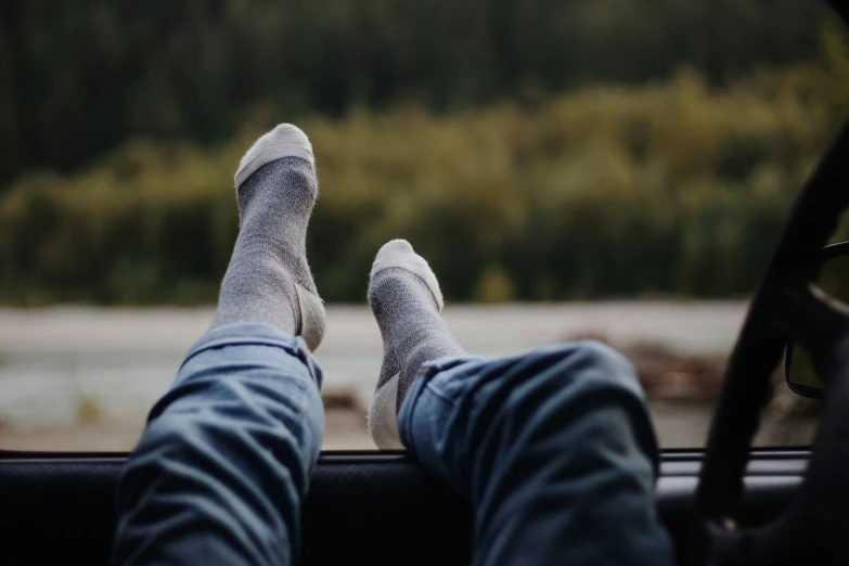 a person with their feet propped up in a vehicle