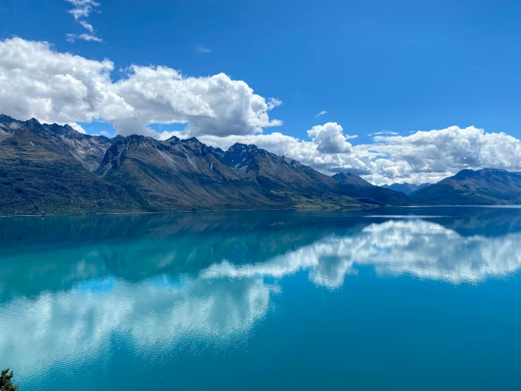 the water is crystal blue with clouds in it