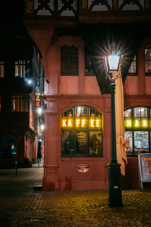 the building is red with lights at night time