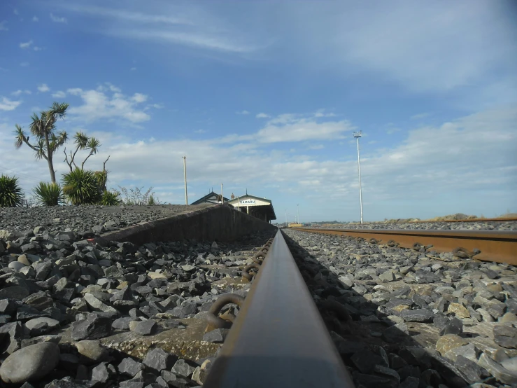 a railway track leading away from a power station