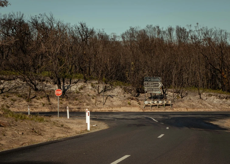 a large road with a sign and several trees