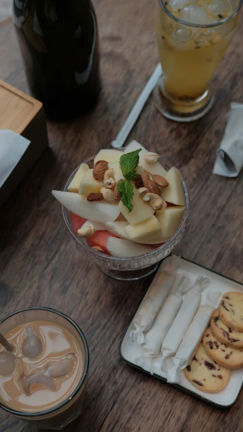 fruit in small containers and plates, a beverage on the side