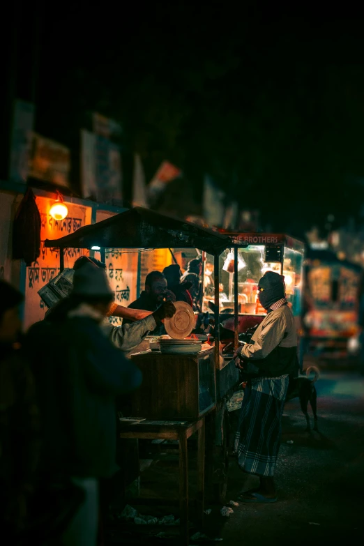 a street vendor at night displaying his ware