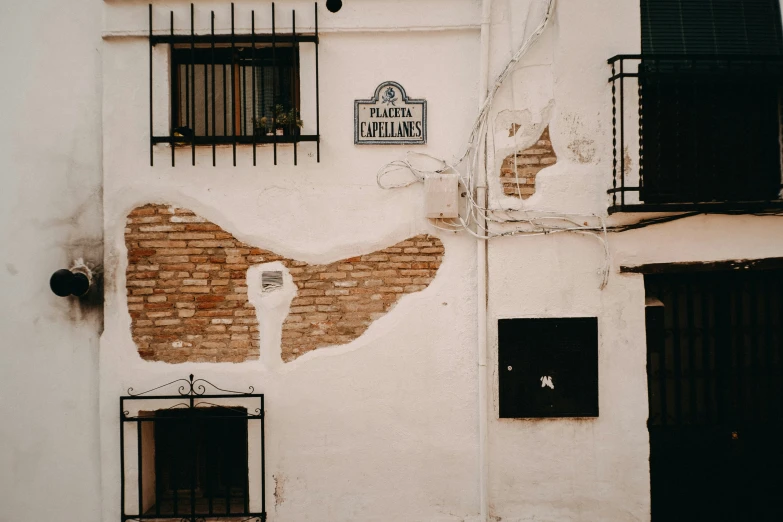 some bricked buildings and black shutters are next to each other