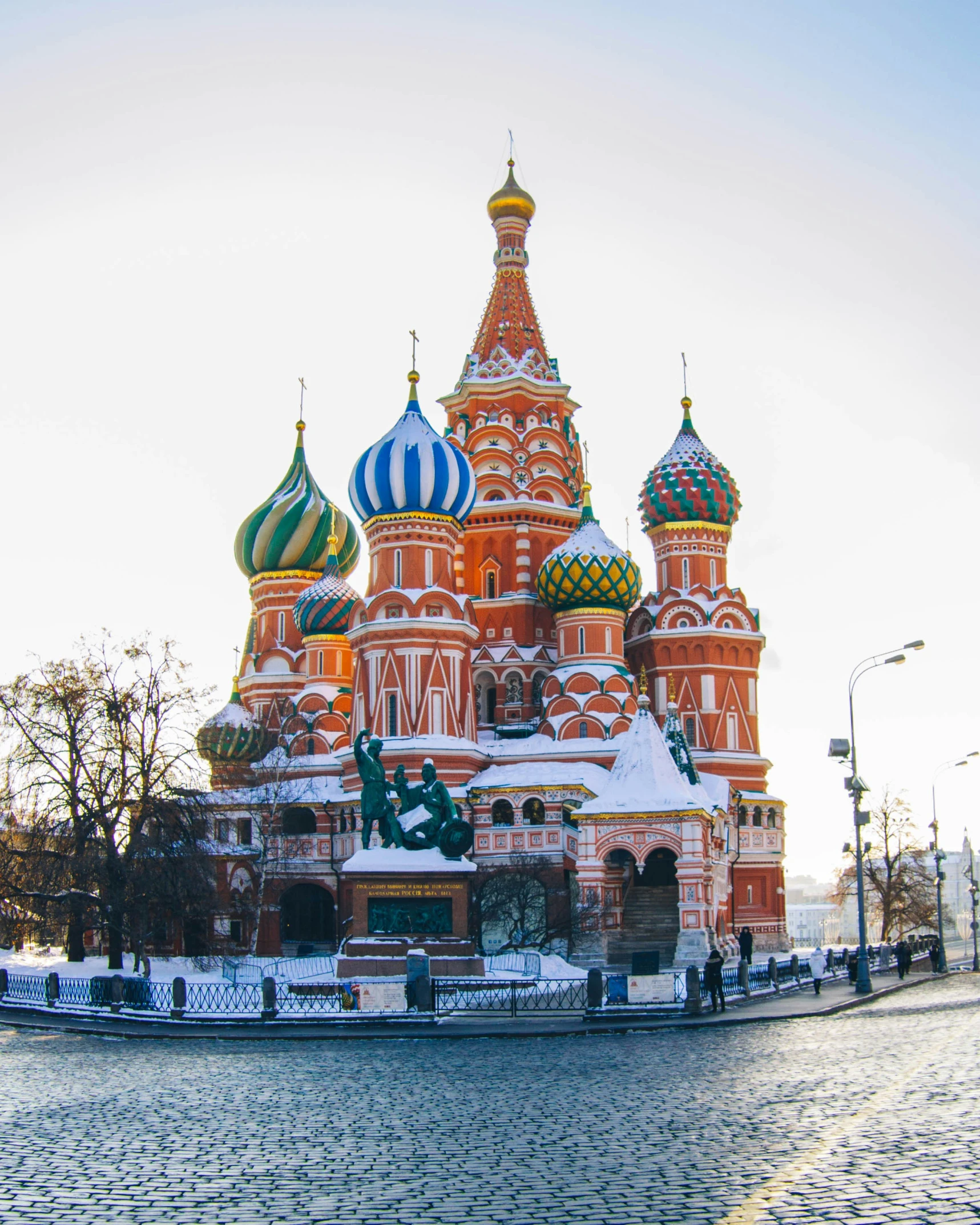 a large church surrounded by snow on a sunny day