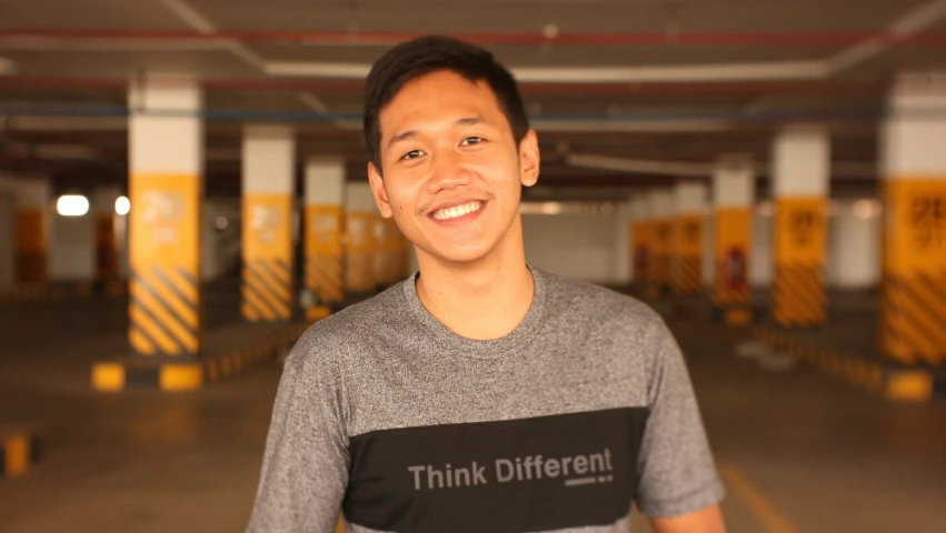 a man that is standing in front of some yellow containers