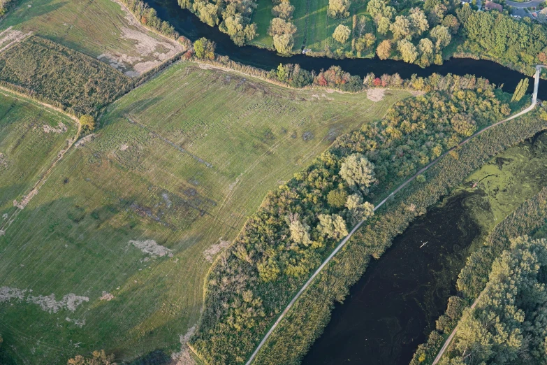 the river from the air shows a narrow waterway in the middle of a wooded area