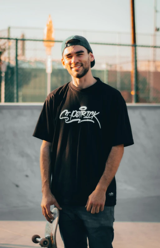 a man wearing a cap holding a skateboard