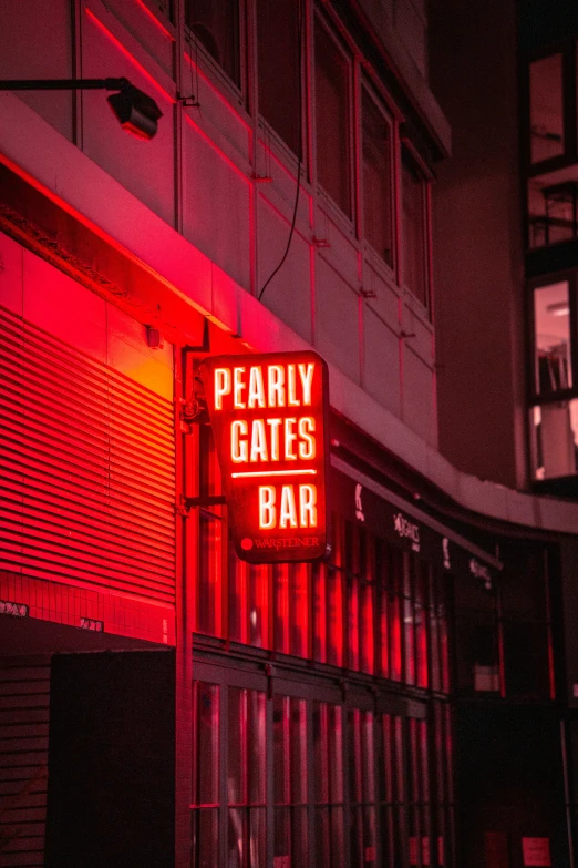 a neon sign on the side of a building that says pearlly gates bar