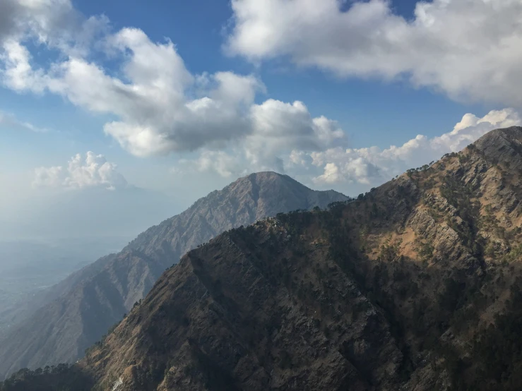 there is a very tall mountain with clouds