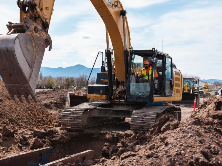 a machine digging through some dirt to load sand