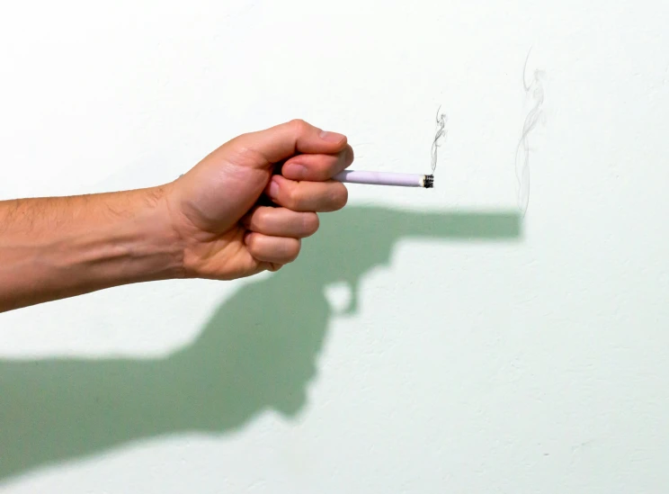 a hand is holding an open cigarette with a cigarette in it