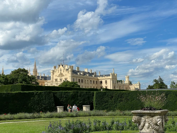 the castle is next to a hedge that extends over to its yard