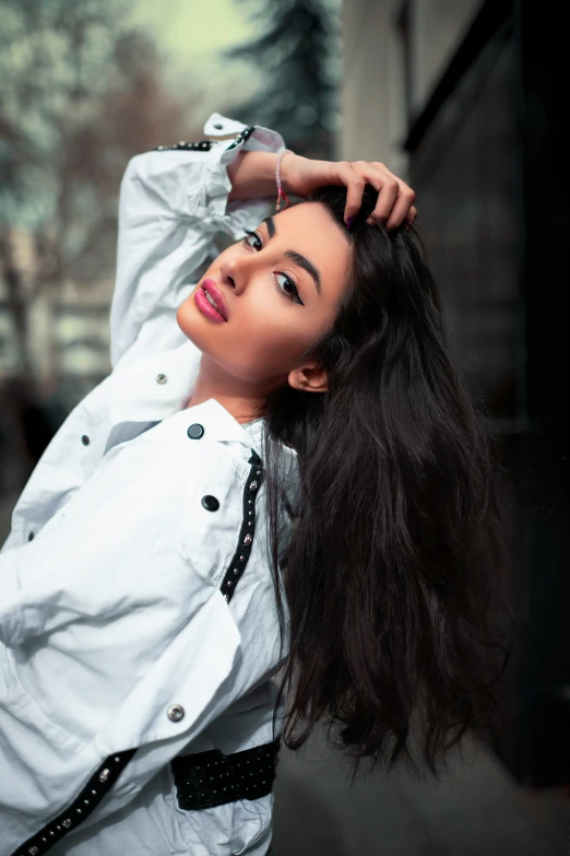 a woman is posing wearing a white shirt