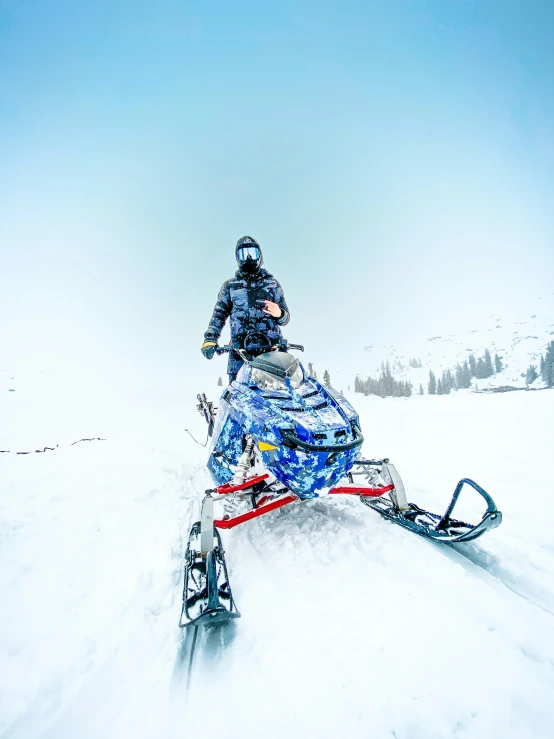 a person riding on the back of a snowmobile
