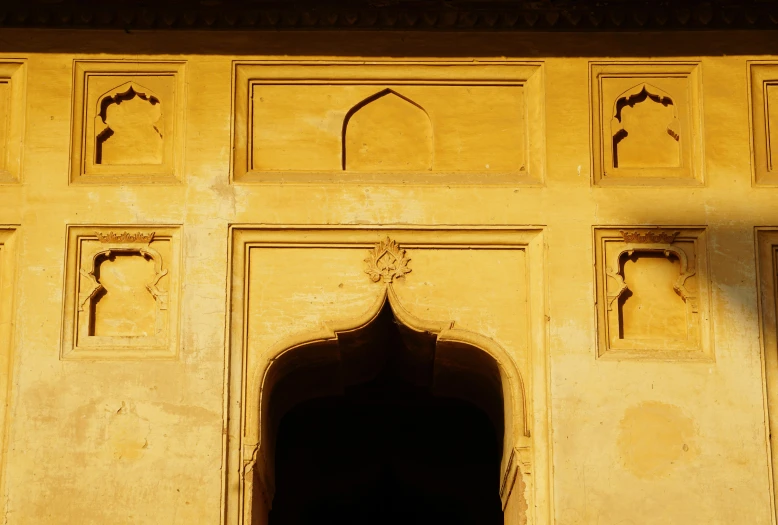 an ornate archway is next to a carved wall