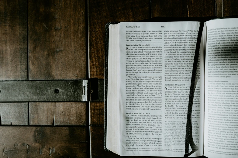 an open book and a tie with writing on it