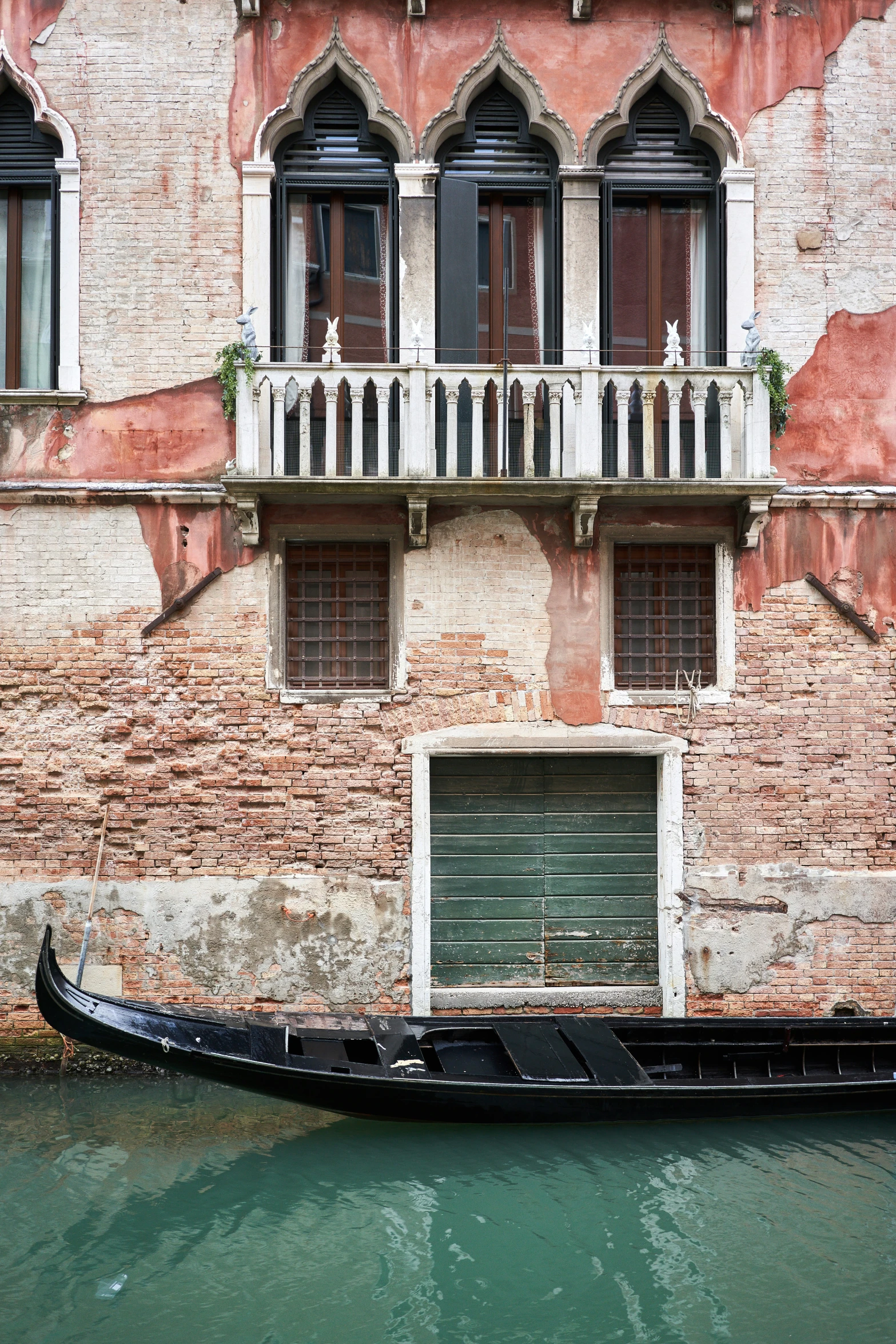 a black gondola sits in front of a building