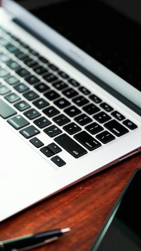 a notebook next to a mac book on a desk