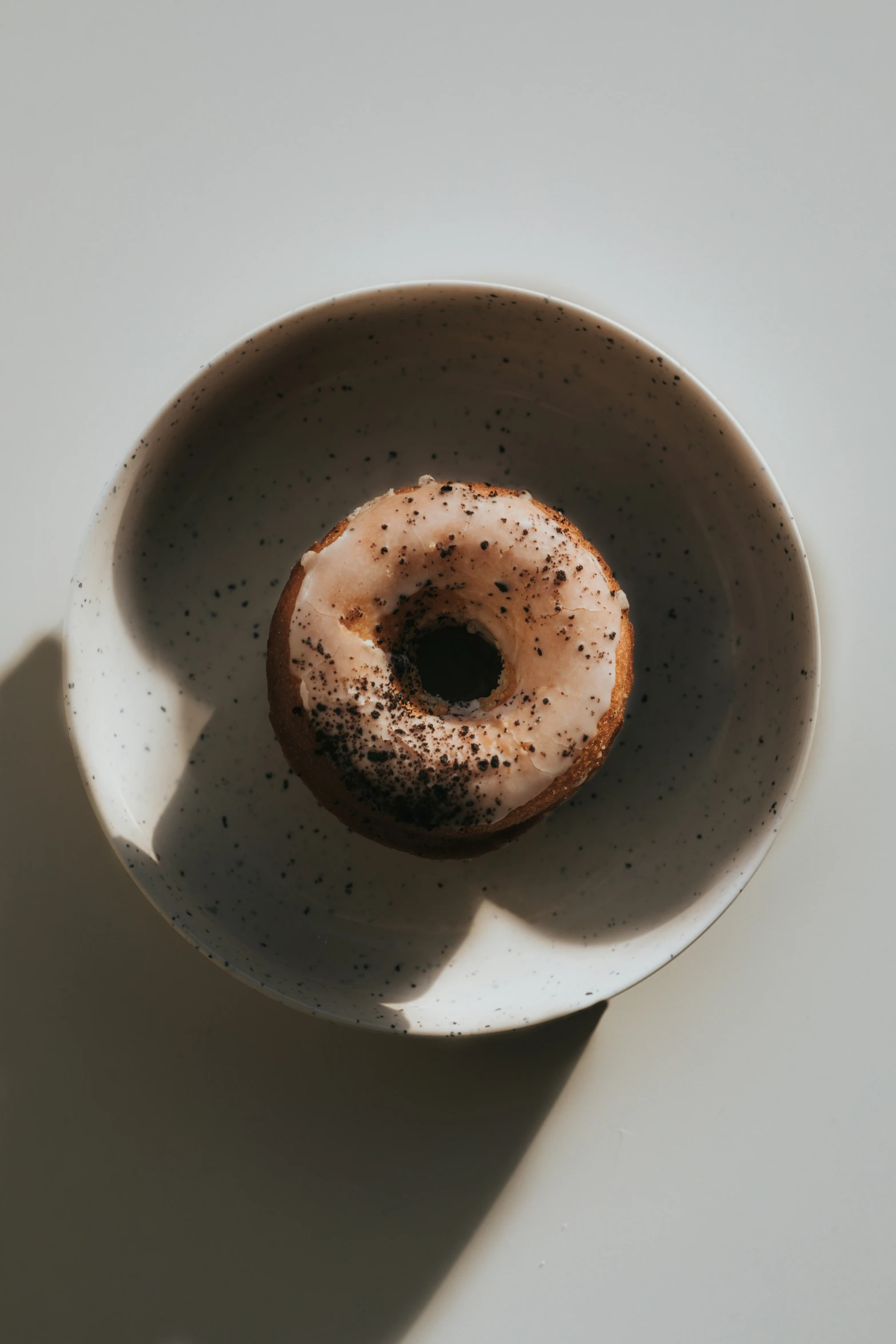 an old fashioned glazed donut in a white bowl