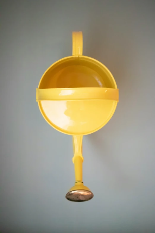 a yellow wall mounted pot holder in a kitchen