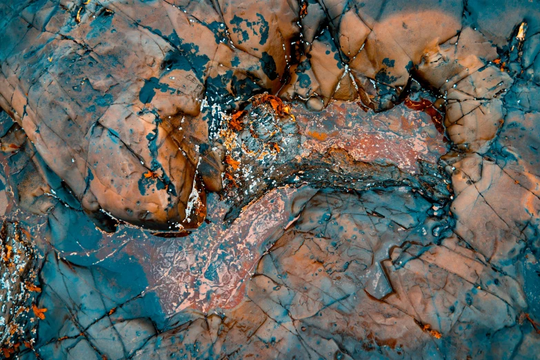 rocks and water with a rusted surface as seen from above