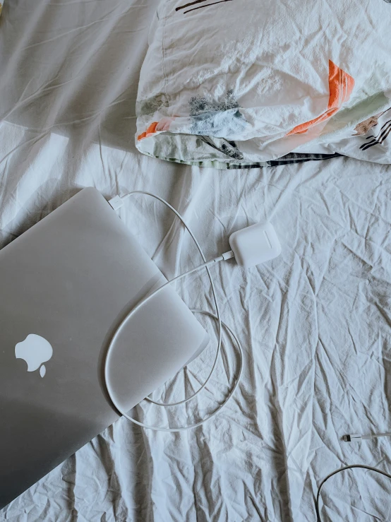 an image of a bed with a computer and its accessories