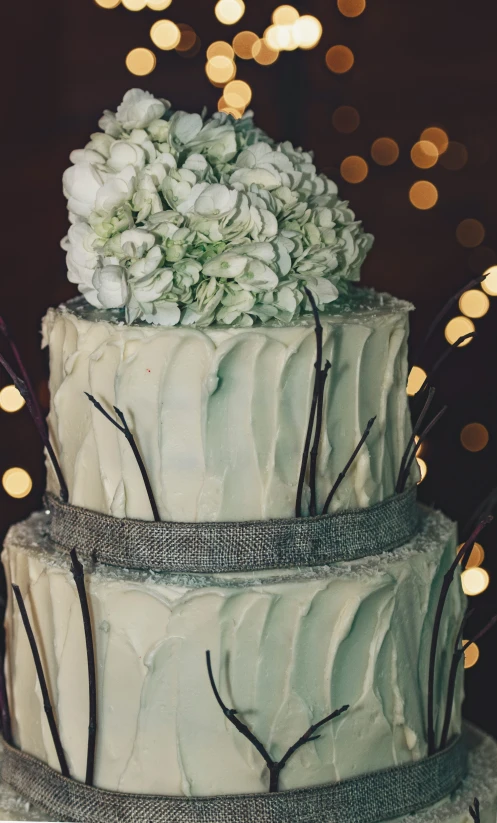 a three tiered cake with flowers on top