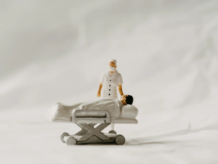 a white table with an acupregululation chair and a miniature man on it